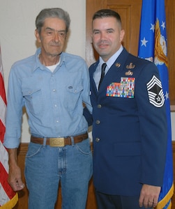 Joseph May, Sr. and Chief Master Sgt. Joseph May, Jr., Air Education and Training Command's explosive ordnance disposal functional manager, pause before the chief's ceremony Aug. 1. During the ceremony, Chief May received a triple crown -- he was officially promoted to chief master sergeant and awarded his first Combat Action Medal and second Bronze Star. (U.S. Air Force photo by Rich McFadden)