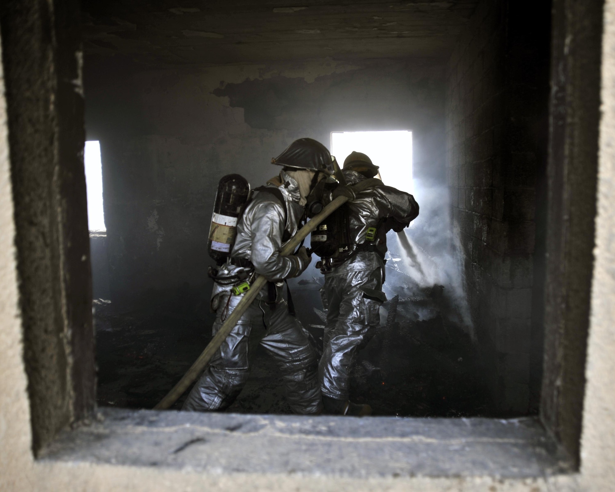 8/5/2008 - BAGHDAD INTERNATIONAL AIRPORT, Iraq - Firefighters from the 447th Expeditionary Civil Engineer Squadron and Baghdad International Airport conduct combined training during a live fire exercise. (U.S. Air Force Photo by Master Sgt. Brian Davidson)