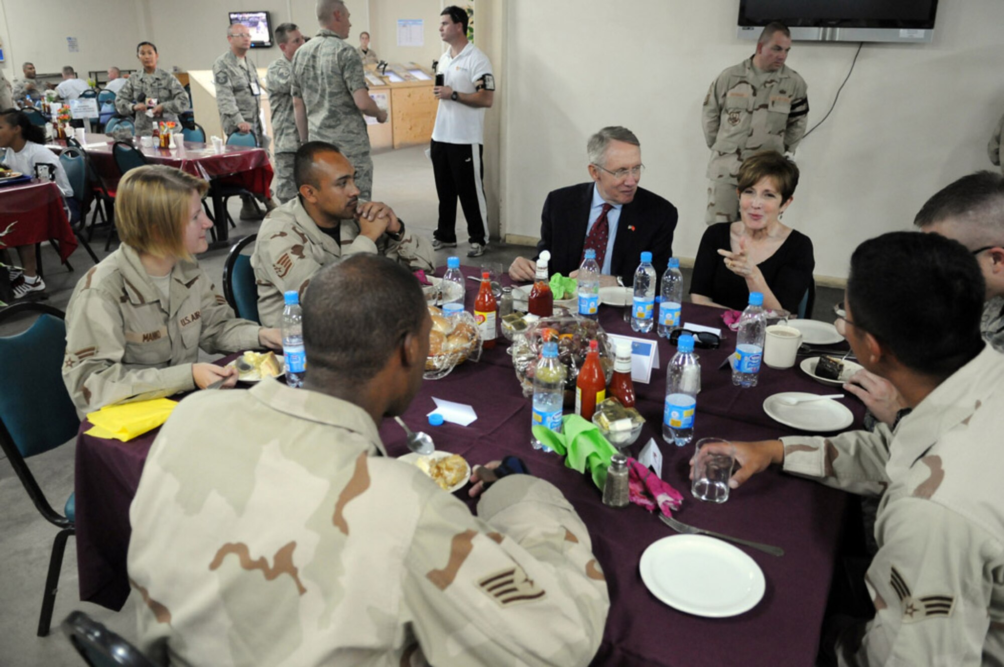 Sen. Harry Reid and his wife, Landra, talk with Airmen from his home state of Nevada during a luncheon at Manas, Aug. 5. The Nevada congressman and U.S. Senate majority leader led a congressional delegation that visited the base as a part of an eight-day congressional delegation trip to promote security, democracy and development in central Asia. While at Manas, the senators visited with deployed Airmen and learned about the wing's mission as an air mobility hub supporting operations in Afghanistan. (U.S. Air Force photo/Airman 1st Class Ruthann Holcomb) 
