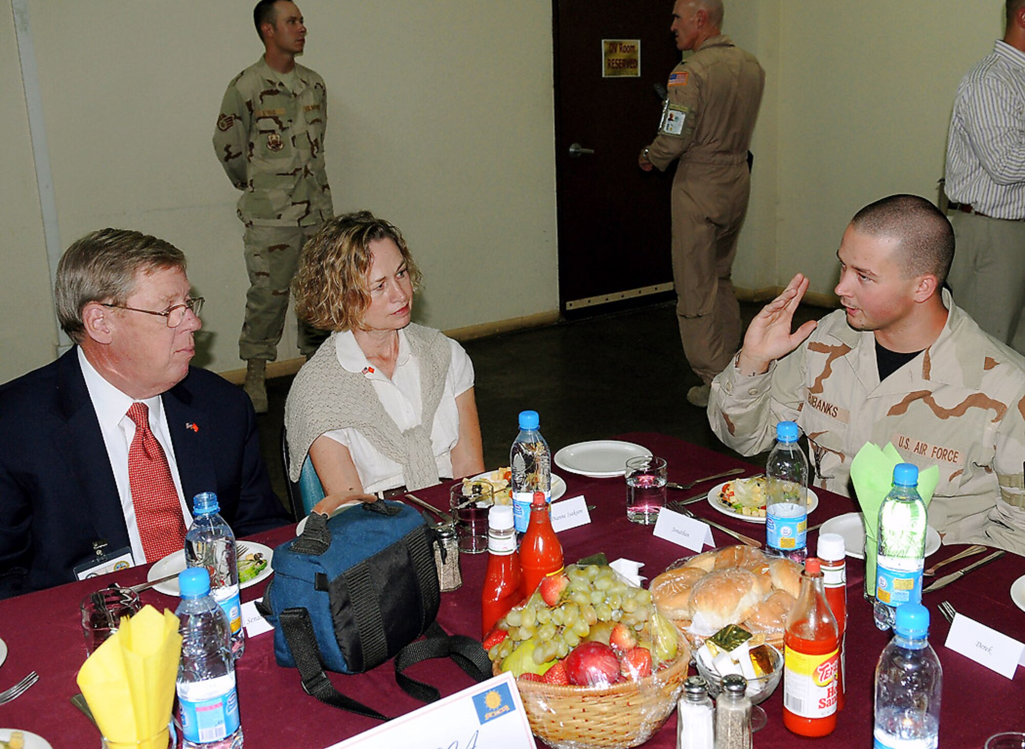 Sen. Johnny Isakson and his wife, Diane, talk with Senior Airman Jonathan Eubanks, a Macon, Ga., native deployed to Manas and assigned to the 376th Expeditionary Logistics Readiness Squadron. The Georgia senator and four others visited Manas, Aug. 5, as a part of an eight-day congressional delegation trip to promote security, democracy and development in central Asia. While at Manas, the senators visited with deployed Airmen and learned about the wing's mission as an air mobility hub supporting operations in Afghanistan. (U.S. Air Force photo/Airman 1st Class Ruthann Holcomb) 
