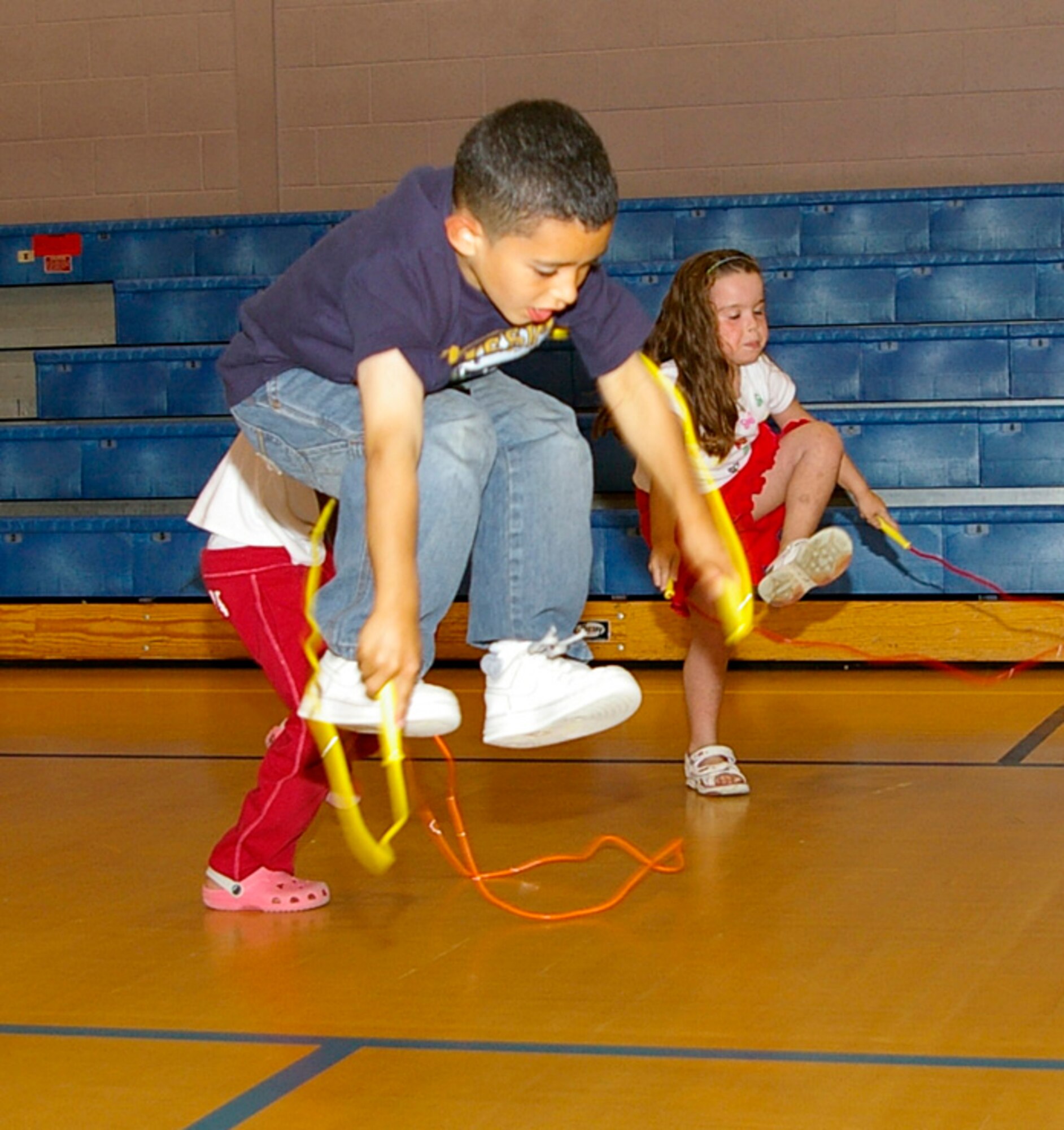 Emmanuel Sepulveda, 6, 100th Operations Support Squadron family member, leaps high in the air as he uses a jump rope during a children's circuit class at the youth center Aug. 1. The 100th Force Support Squadron put together the mini-circuit class for children at the youth center to provide an extra way to keep children entertained. (U.S. Air Force photo by Karen Abeyasekere)