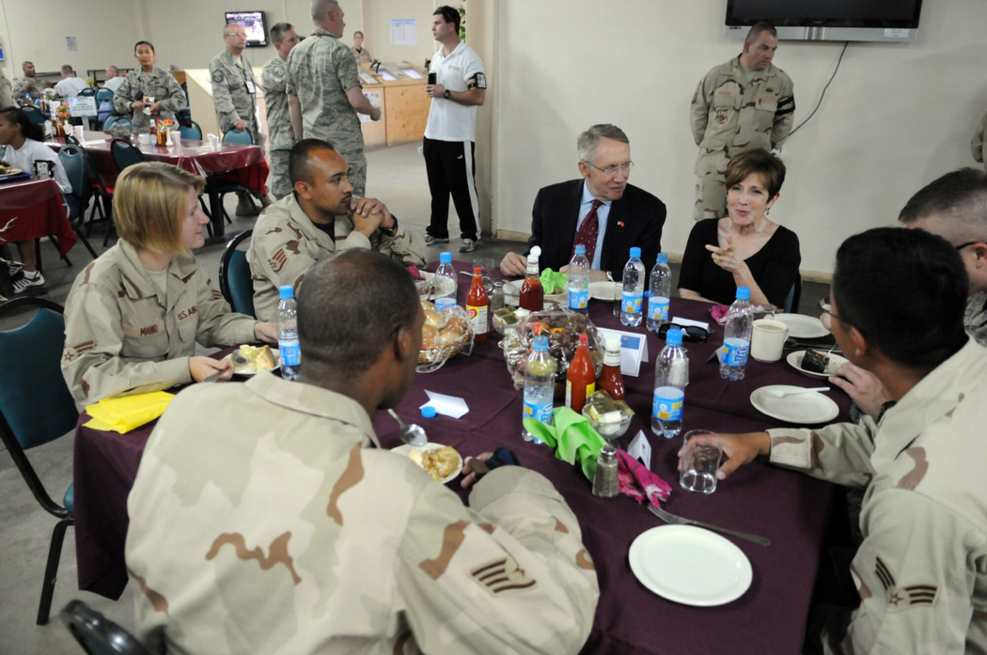 MANAS AIR BASE, KYRGYZ REPUBLIC -- Sen. Harry Reid and his wife, Landra, talk with Airmen from his home state of Nevada during a luncheon at Manas, Aug. 5. The Nevada congressman and U.S. Senate majority leader led a congressional delegation that visited the base as a part of an eight-day congressional delegation trip to promote security, democracy and development in central Asia. While at Manas, the senators visited with deployed Airmen and learned about the wing's mission as the premier air mobility hub supporting operations in Afghanistan. (Air Force photo / Airman 1st Class Ruthann Holcomb)