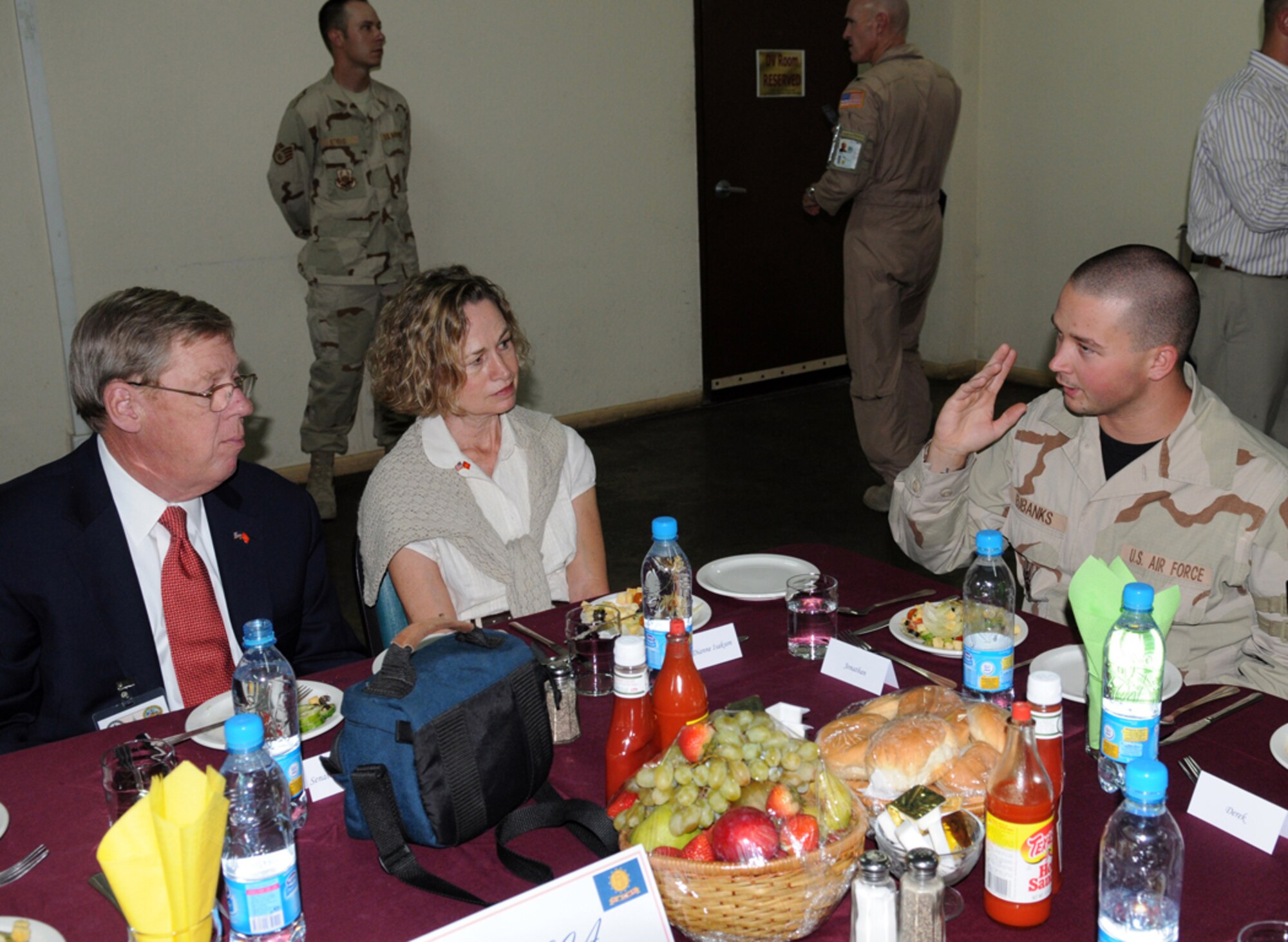 MANAS AIR BASE, KYRGYZ REPUBLIC -- Sen. Johnny Isakson and his wife, Diane, talk with Senior Airman Jonathan Eubanks, a Macon, Ga., native deployed to Manas and assigned to the 376th Expeditionary Logistics Readiness Squadron. The Georgia senator and four others visited Manas, Aug. 5, as a part of an eight-day congressional delegation trip to promote security, democracy and development in central Asia. While at Manas, the senators visited with deployed Airmen and learned about the wing's mission as the premier air mobility hub supporting operations in Afghanistan. (Air Force photo / Airman 1st Class Ruthann Holcomb)