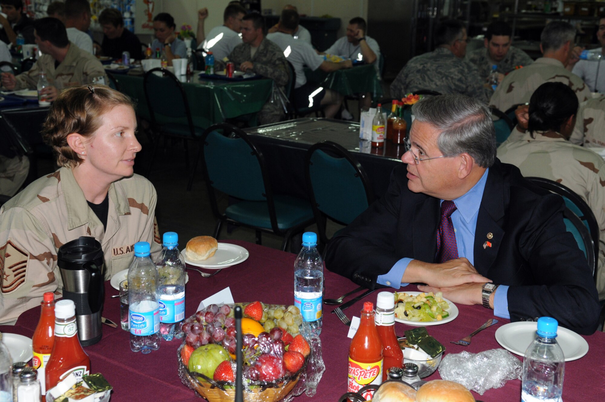 MANAS AIR BASE, KYRGYZ REPUBLIC -- Sen. Robert Menendez talks with Master Sgt. Suzanne Roe, 376th Expeditionary Civil Engineer Squadron first sergeant who is deployed from McGuire Air Force Base, N.J. The New Jersey senator and four others visited Manas, Aug. 5, as a part of an eight-day congressional delegation trip to promote security, democracy and development in central Asia. While at Manas, the senators visited with deployed Airmen and learned about the wing's mission as the premier air mobility hub supporting operations in Afghanistan. (Air Force photo / Airman 1st Class Ruthann Holcomb)