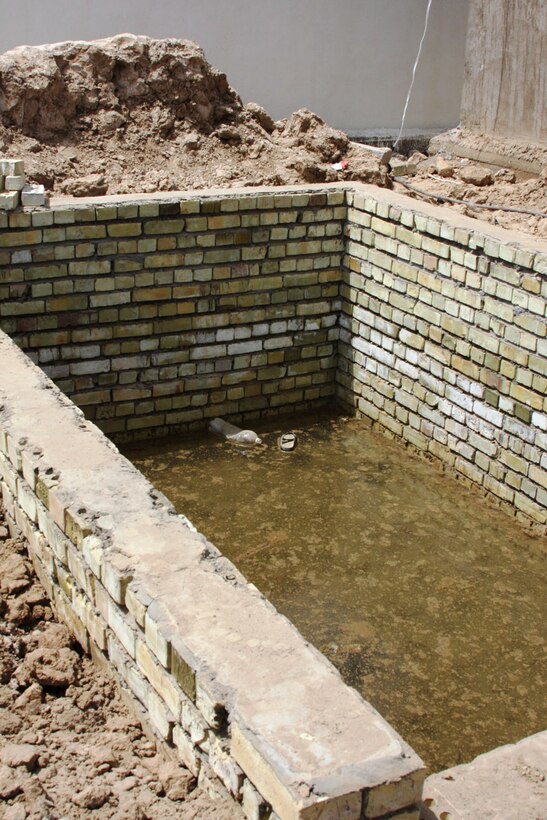 Work on a new septic tank for the Qadasiya Primary School in Tarmiyah, Iraq, northwest of Baghdad, is almost complete. When the work is completed, schools will have working septic tanks, new pipes, renovated bathrooms, new paint and new doors, as well as supplies. U.S. Army photo by Pfc. Lyndsey Dransfield, Multinational Division Baghdad