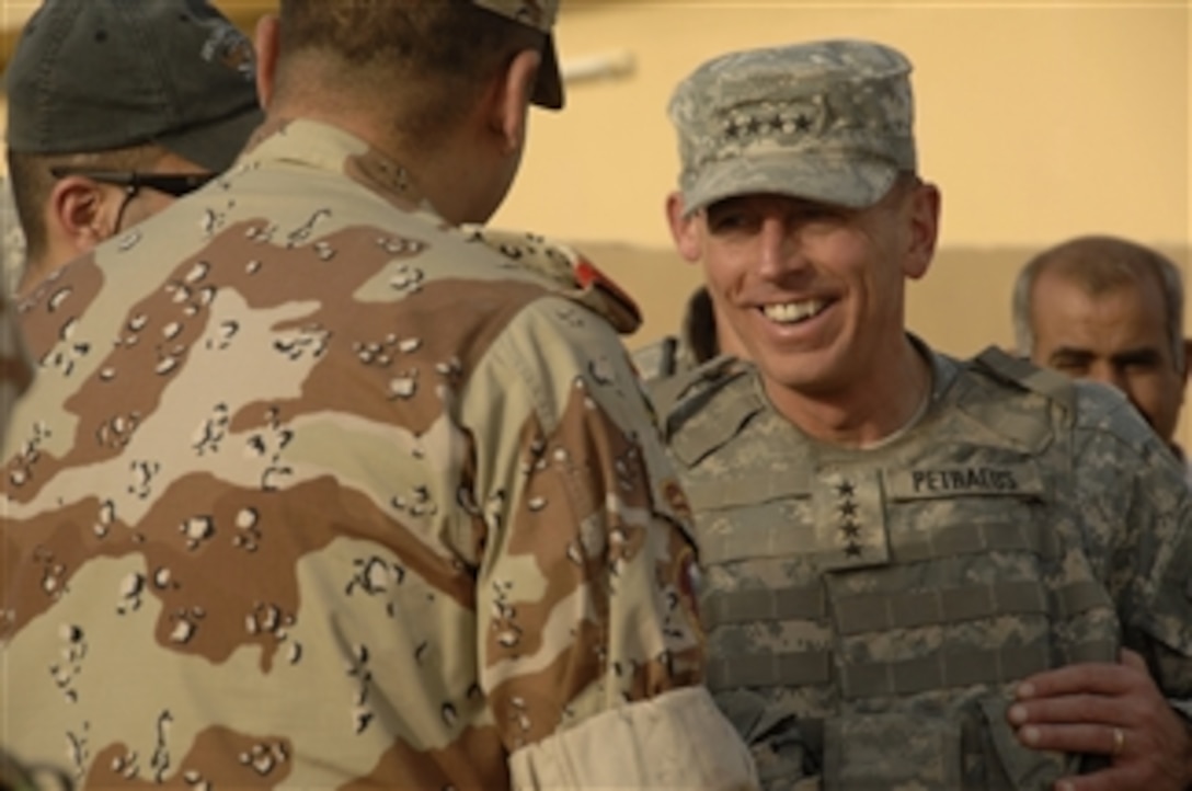 Commanding General of Multi-National Force-Iraq Gen. David Petraeus, U.S. Army, bids farewell to an Iraqi army general after completing a tour of a market in Abu Ghraib, Iraq, on Aug. 2, 2008.  