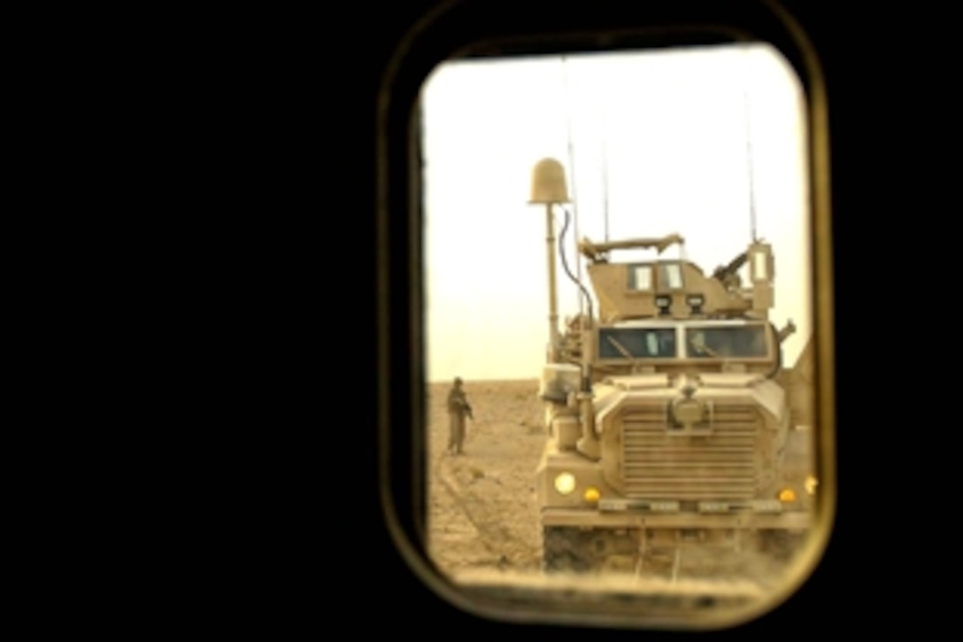 U.S. Marines use a Mine-Resistant Ambush-Protected vehicle to pull out another MRAP on their way to Trailer Town, Iraq, July 31, 2008. The Marines are assigned to Bravo Battery, 2nd Low Altitude Air Defense Battalion, and Navy sailors conducted a Cooperative Medical Engagement for Iraqi families that cannot afford medical attention. 