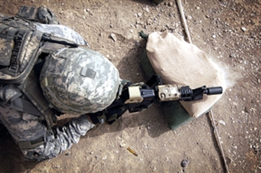 U.S. Army Staff Sgt. Conrad Vasquez fires his weapon during weapons qualification at a firing range on Camp Taji, Iraq, Aug. 3, 2008. Vasquez is assigned to the 14th Cavalry Regiment, 25th Infantry Division. 