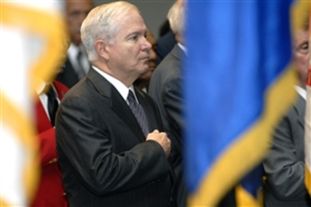 Defense Secretary Robert M. Gates gives honors during the playing of the national anthem in the Pentagon Auditorium Aug. 6, 2008, at a ceremony to mark the 60th anniversary of the signing of Executive Orders 9980 and 9981, which integrated the armed forces and federal civil service. 