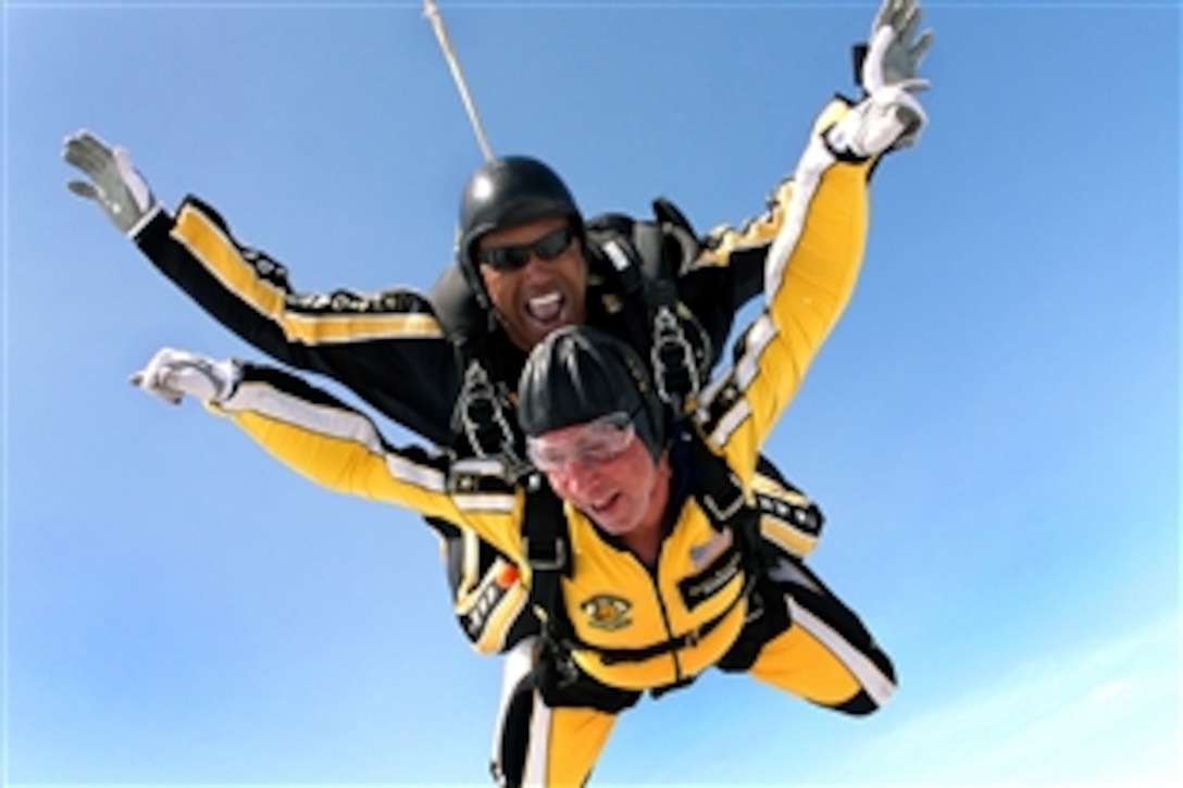 U.S. Army Sgt. 1st Class Michael Elliott, an instructor with the Army's Golden Knights parachute team, dives tandem with Jon D. Port, a command master chief,  bottom, in Maxton, N.C., Aug 1, 2008. 