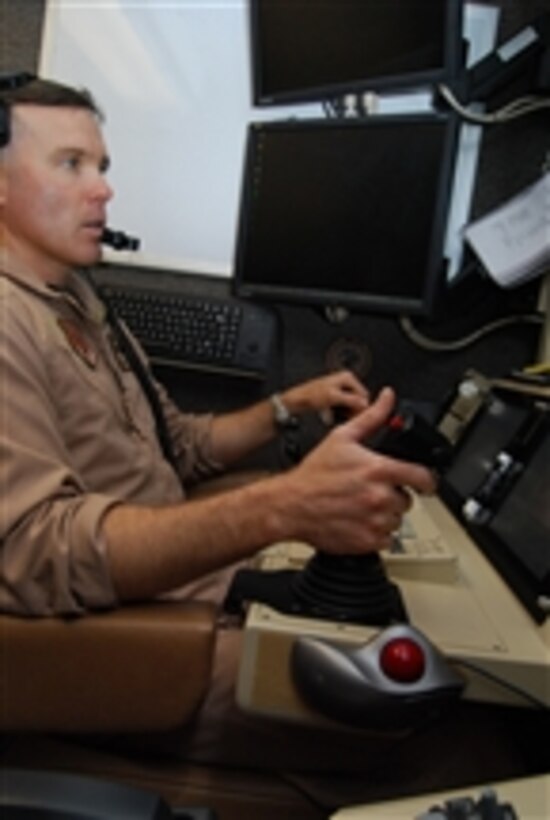 U.S. Air Force Maj. John Chesser operates the controls of an MQ-9 Reaper unmanned aerial vehicle cockpit during a demonstration at Joint Base Balad, Iraq, on Aug. 1, 2008.  The Reaper is designed as a hunter-killer, capable of loitering over targets for long periods of time and delivering laser-guided ordnance.  Chesser is a Reaper pilot with the 46th Expeditionary Reconnaissance and Attack Squadron.  