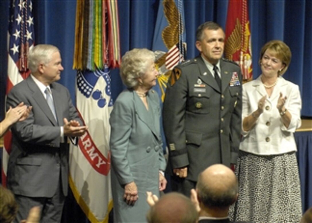 Secretary of Defense Robert M. Gates (left) applauds Gen. Peter Chiarelli, joining in with Chiarelli's mother Audrey and wife Beth (right) during a ceremony in the Pentagon on Aug. 4, 2008.  Chiarelli, who previously served as senior military assistant to Gates, was both promoted and sworn-in as the Army's vice chief of staff.  