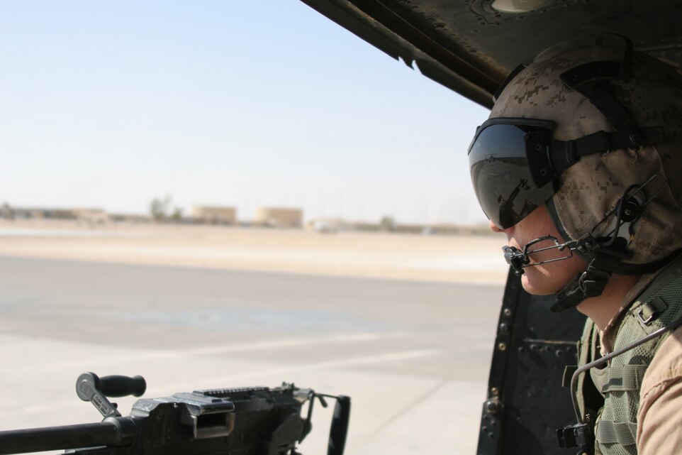 Prior to take off Aug. 6, Cpl. Casey Feasby, a crew chief with Marine Light Attack Helicopter Squadron 167 monitors the runway. The squadron participated in training with 1st Air Naval Gunfire Liaison Company to enhance the skills needed to provide close air support during combat operations. During the training, Feasby manned the M-240G medium machine gun.
