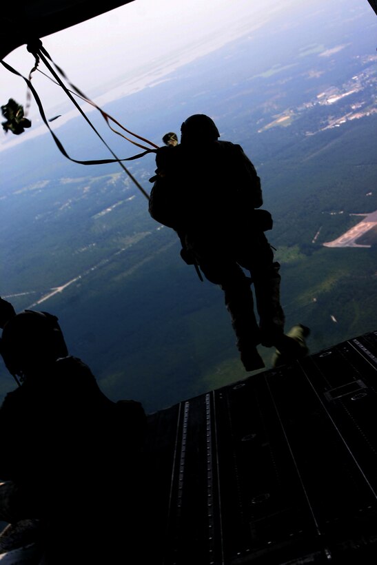 A Marine with U.S. Marine Corps Forces, Special Operations Command drops from the ramp of the MH-47D Chinook helicopter from the Army’s 160th Special Operations Aviation Regiment over Drop Zone Pheasant here, August 6.