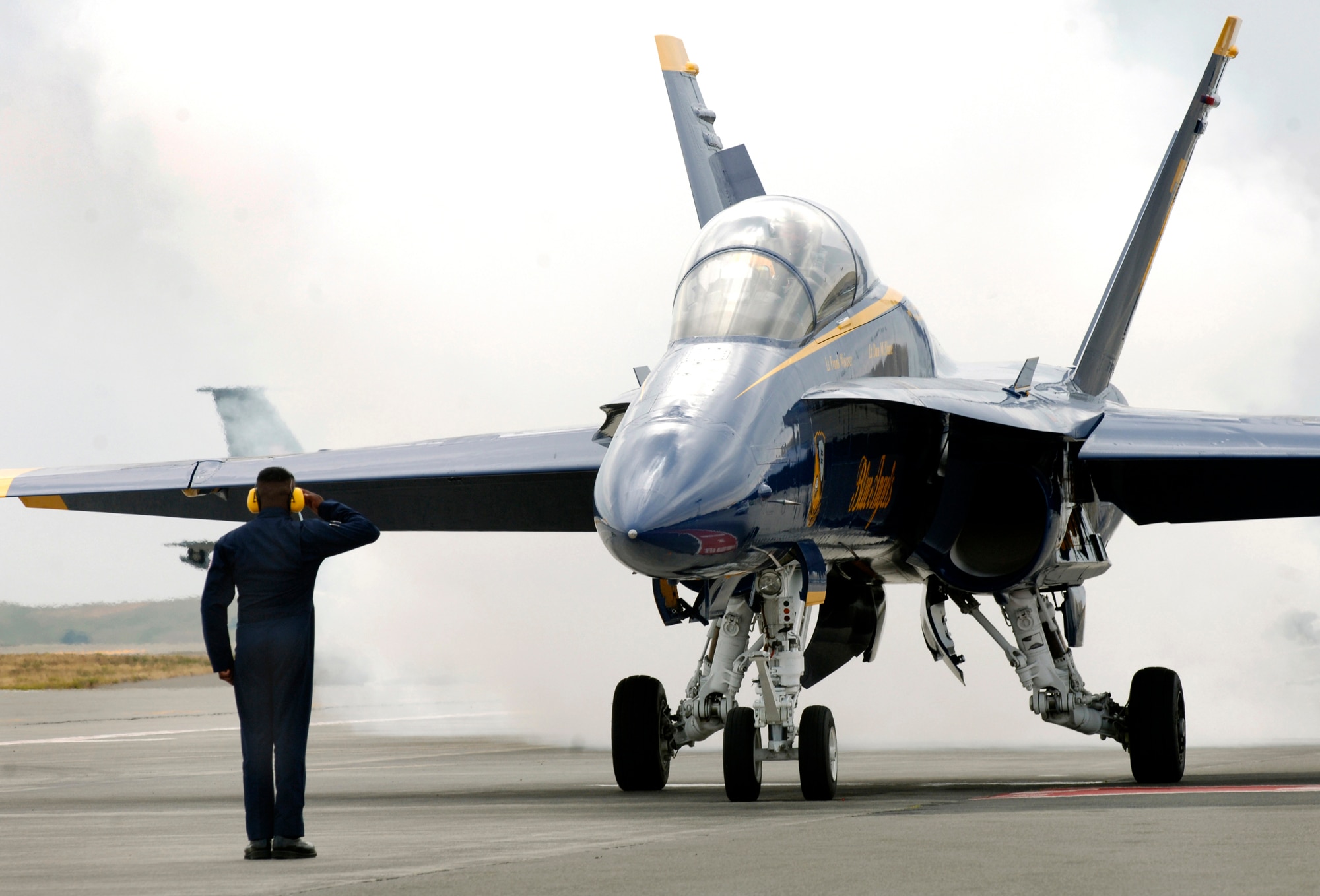 FAIRCHILD AIR FORCE BASE, Wash. – U.S. Marine Corps Staff Sgt. Deo Harrypersaud, Navy Blue Angels number seven crew chief and crew chief supervisor, presents a final salute to his jet as it prepares for lift off from Fairchild's airfield Aug. 7. (U.S. Air Force photo / Airman 1st Class Joshua K. Chapman)