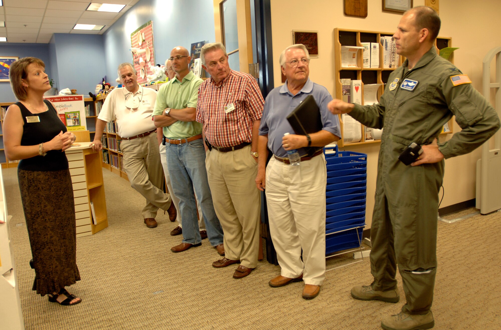 MCCONNELL AIR FORCE BASE, Kan. -- Col. James Vechery, 22nd Air Refueling Wing commander, right, and Darla Cooper, base library director, left, explain the services available at the base library to a group of honorary commanders and a Golden Eagle during an Honorary Commander Orientation Day, Aug. 1. Honorary commanders are civilian leaders whose civic positions mirror that of McConnell’s group and squadron commanders. Golden Eagles are honorary commanders who have demonstrated unparallel community support to McConnell.  Representatives from both groups who attended the orientation witnessed a change of command ceremony; toured the medical clinic; had lunch at the dining facility; visited the Robert J. Dole Community Center and climbed aboard a KC-135 Stratotanker. (photo by Staff Sgt. Amanda Currier.)