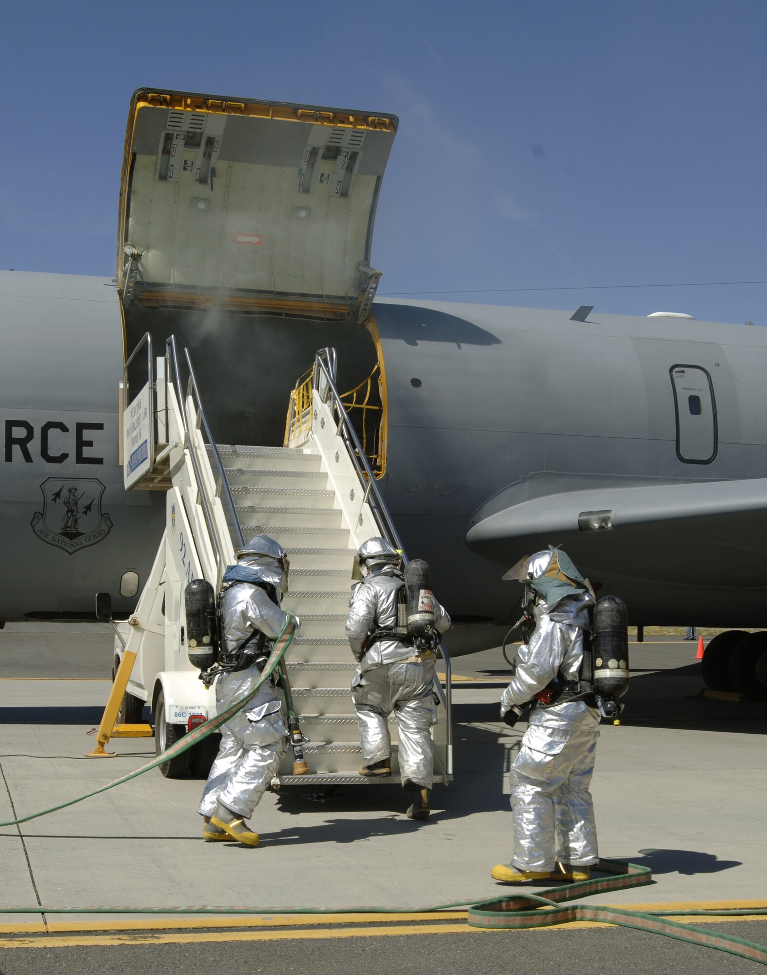 FAIRCHILD AIR FORCE BASE, Wash. — Firefighters from the 92nd Civil Engineer Squadron perfect their response time for a plane crash during a Mass Accident Response Exercise on the flightline here July 28. A KC-135 static display was used to simulate the mock plane crash.  (U.S. Air Force photo / Airman 1st Class Melissa Barnett)