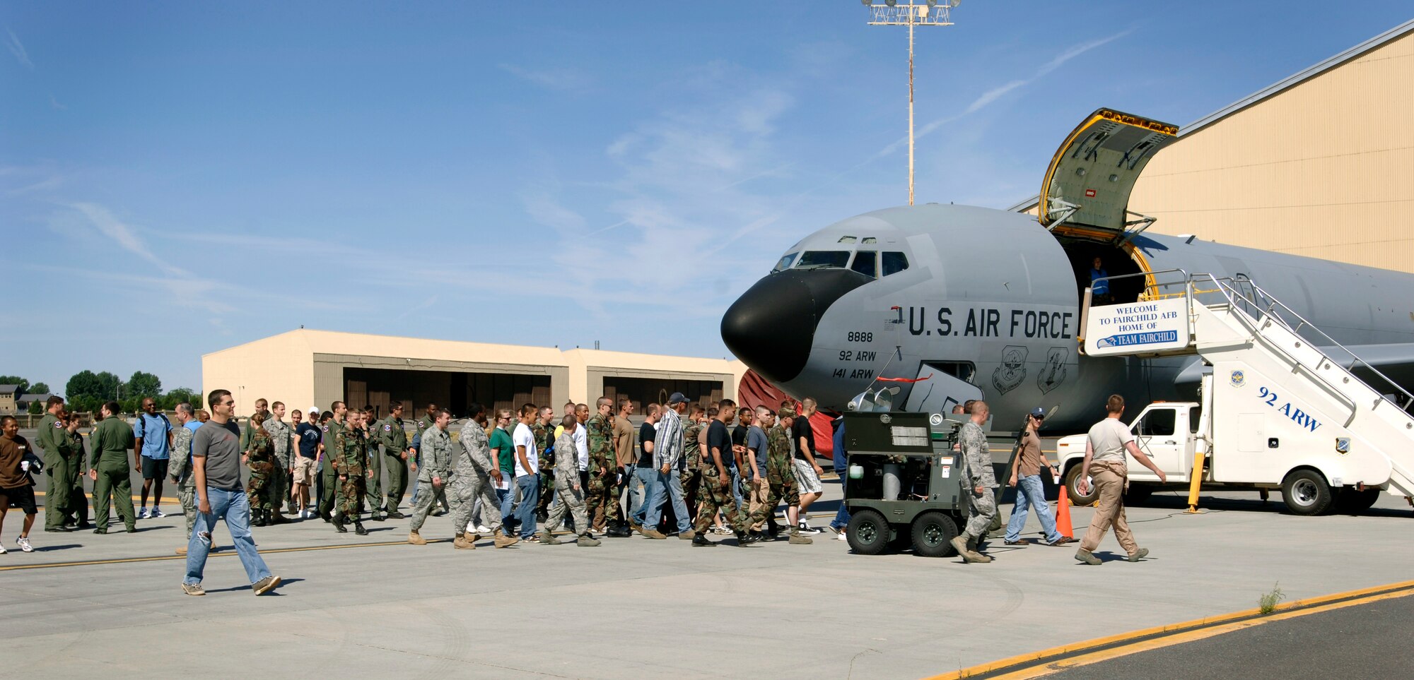 FAIRCHILD AIR FORCE BASE, Wash. — Participants in the Mass Accident Response Exercise disperse to their assigned positions around a KC-135 static display simulating a plane crash on the flightline here July 28. The MARE helps emergency personnel exercise their ability to respond to a major emergency. (U.S. Air Force photo / Airman 1st Class Melissa Barnett)  