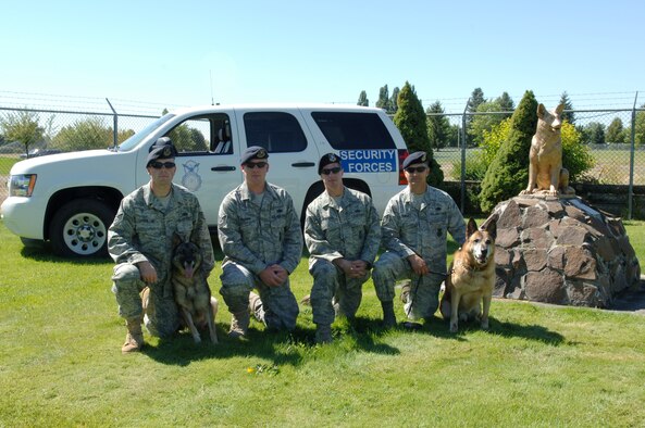 FAIRCHILD AIR FORCE BASE, Wash. – Staff Sgt. Shawn Lindbloom, military working dog Helena, Tech. Sgt. Brandon Tillman, Staff Sgt. Levi Wilson, Tech. Sgt. Max Talley, and MWD Tico, 92nd Security Forces Squadron all from the military working dog section, pose for a group photo as the team who performed a sweep at the Coeur d’ Alene Casino July 16. The team responded to a call early in the morning of a bomb threat to the casino. The team put the minds of the casino officials and guests at ease when no bomb was detected. (U.S. Air Force photo / Senior Airman Jocelyn A. Ford)