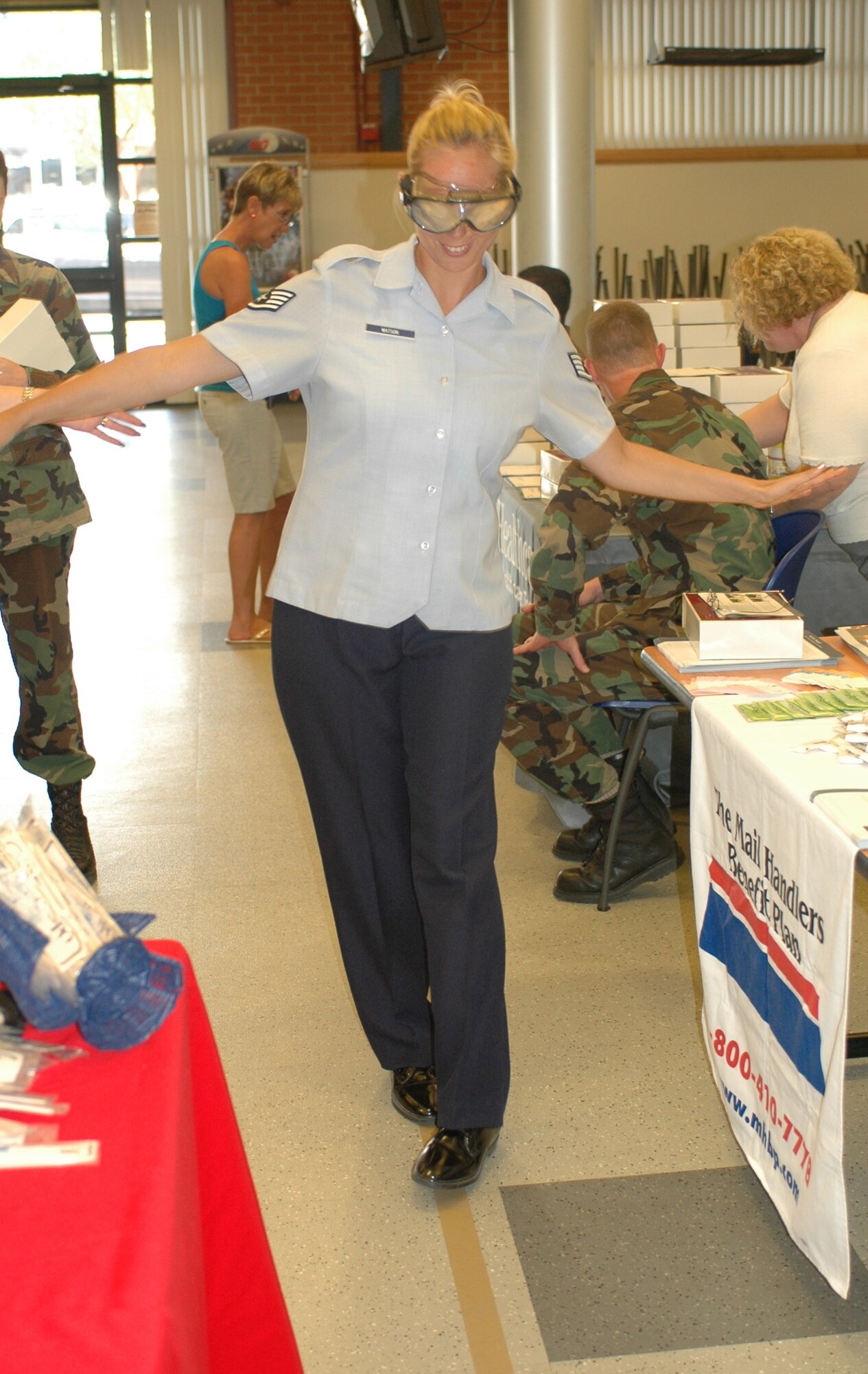 Staff Sgt. Dana Watson attempts to walk a straight line while wearing goggles that simulate the effects of three alcoholic beverages. The health fair held at the 162nd Fighter Wing gave members a close look at everyday issues that affect personal health. (Air National Guard photo by Staff Sgt. Jordan Jones.)
