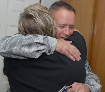 Chief Page hugs Annette Slaydon, wife of Staff Sgt. Matthew Slaydon, an explosive ordnance technician injured while serving in Iraq, during a visit to their home July 14. (U.S. Air Force photo by Rich McFadden)