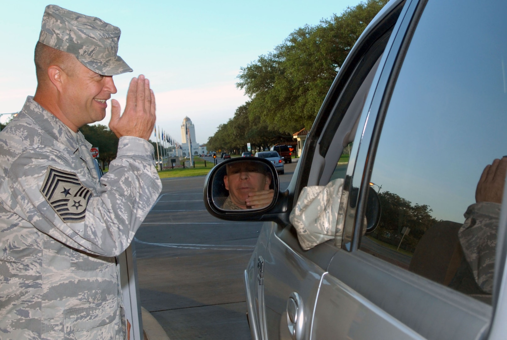 Chief Page salutes an officer while checking identification cards at the front gate recently. The command chief master sergeant was lauded by Air Force Times for living "above and beyond (the) call to service 24/7." (U.S. Air Force photo by Rich McFadden)