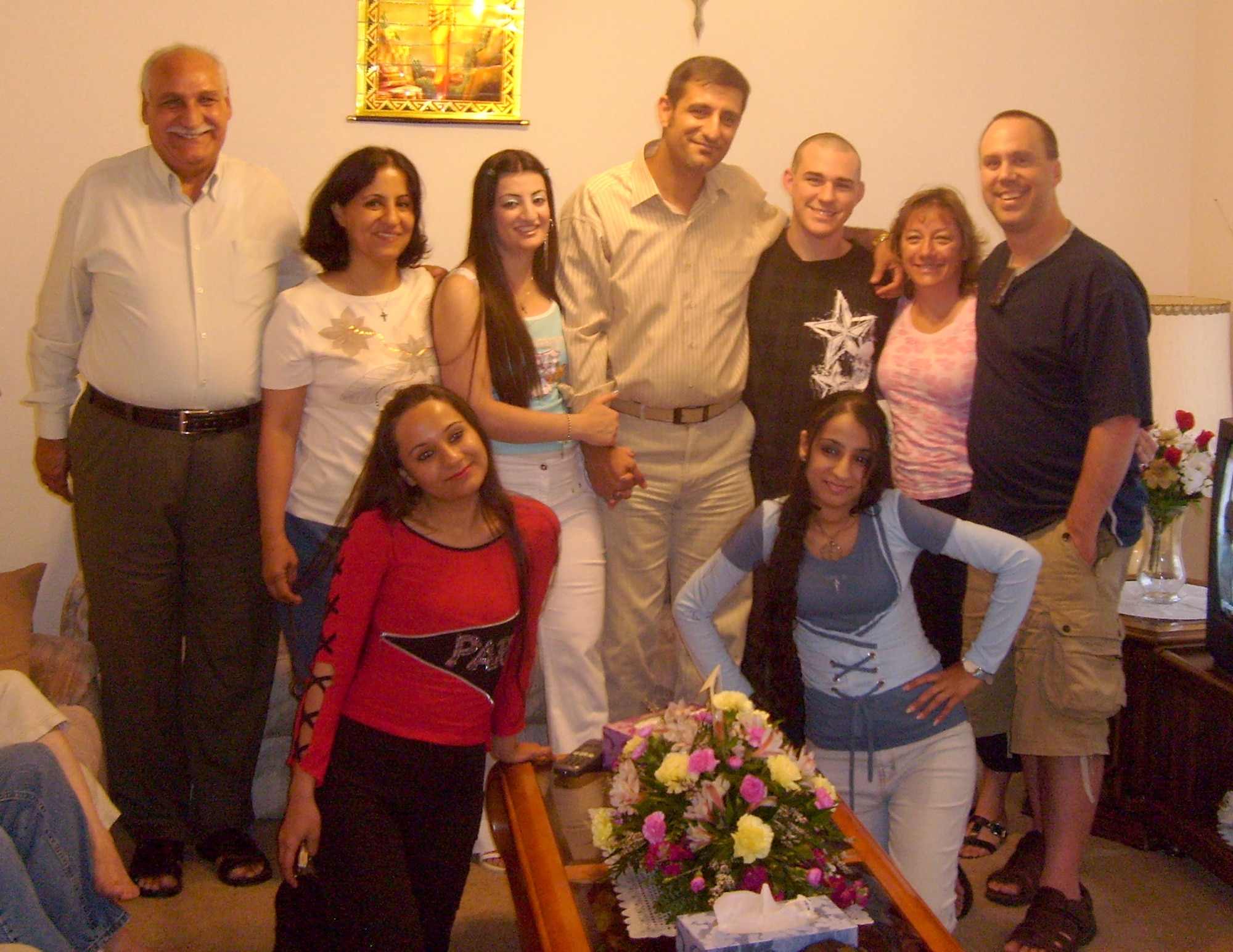 Vincent Talia (center), holds the hand of his wife Nouras, after their wedding anniversary attended by Master Sgt. Greg Jensen (far right) recently. Sergeant Jensen worked with Mr. Talia, an Iraqi citizen who escaped Iraq with the help of the master sergeant, while deployed in support of Operation Iraqi Freedom during 2006. In an interview about helping Mr. Talia and his family to the U.S., Sergeant Jensen said, "I really felt like I owed him. He saved my life." Sergeant Jensen works in the Air Force Space Command Inspector General Office. (Courtesy photo)