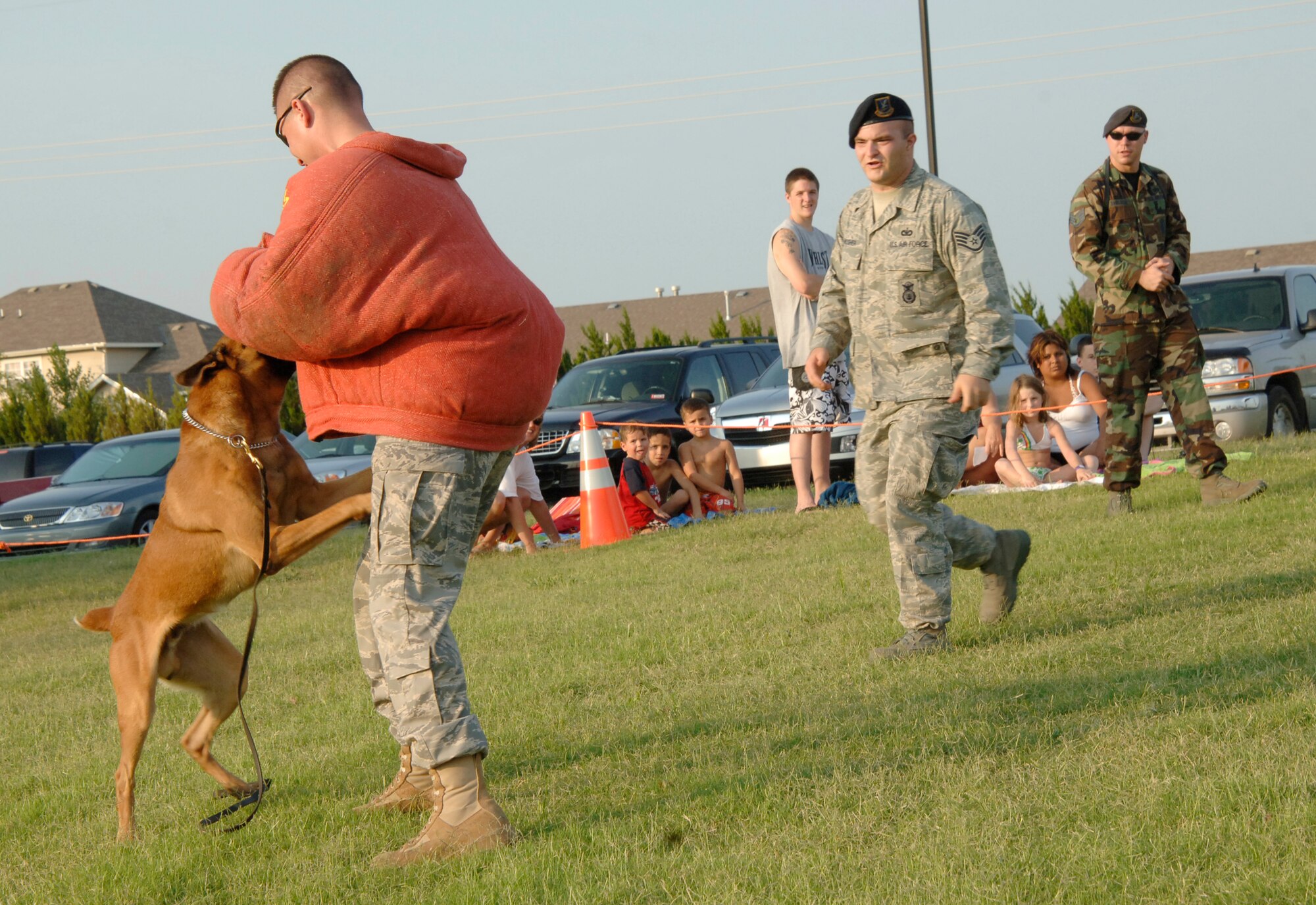 MCCONNELL AIR FORCE BASE, Kan. –- Tech. Sgt. Andrew Bedell, 22nd Security Forces Squadron, is attacked by Military Working Dog Iindy while Iindy’s handler, Staff Sgt. Matt Mosher, 22nd Security Forces Squadron, walks forward saying, “Get’em”, during a dog demonstration at National Night out at Rock River Rapids in Derby, Aug. 5. National Night Out is a way for citizens to participate in local anticrime programs with police and security forces. (Photo by Senior Airman Roy Lynch III)