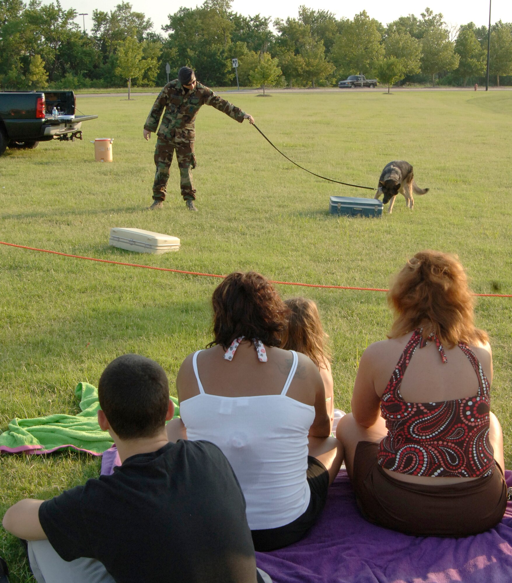 MCCONNELL AIR FORCE BASE, Kan. –- Onlookers watch while Staff Sgt. Jason Sheldon, 22nd Security Forces Squadron, waits for Military Working Dog Sheryl to sniff out explosives for a MWD performance during National Night out at Rock River Rapids in Derby, Aug. 5. Members of the 22nd Security Forces Squadron teamed up with Derby Police Department for the 25th Annual National Night Out to educate citizens on crime and drug prevention. (Photo by Senior Airman Roy Lynch III)