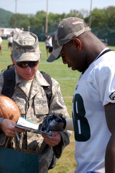 Philadelphia Eagles defensive end Trent Cole signs an autograph for Tech. Sgt. Robert Metrision of the U.S. Air Force Expeditionary Center, Fort Dix, N.J., during Military Day at the Eagles training camp Aug. 5, 2008, at Lehigh University in Lehigh, Penn.  More than 200 military members from all the services, including more than 50 Airmen from McGuire Air Force Base and Fort Dix, N.J., attended the event where they were served breakfast and held a meet and greet with Eagles staff and players.  (U.S. Air Force Photo/Tech. Sgt. Scott T. Sturkol)