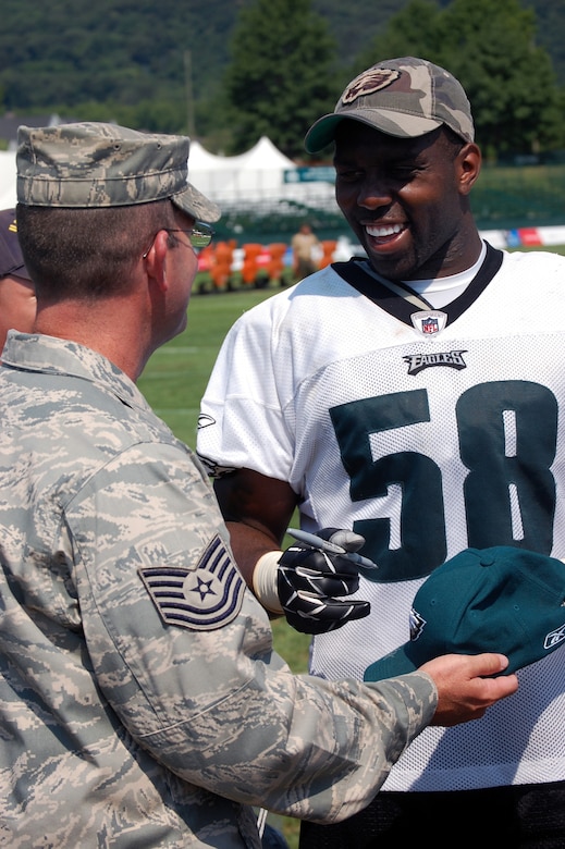 Philadelphia Eagles defensive end Trent Cole signs an autograph for Tech. Sgt. William Lipsett of the U.S. Air Force Expeditionary Center, Fort Dix, N.J., during Military Day at the Eagles training camp Aug. 5, 2008, at Lehigh University in Lehigh, Penn.  More than 200 military members from all the services, including more than 50 Airmen from McGuire Air Force Base and Fort Dix, N.J., attended the event where they were served breakfast and held a meet and greet with Eagles staff and players.  (U.S. Air Force Photo/Tech. Sgt. Scott T. Sturkol)