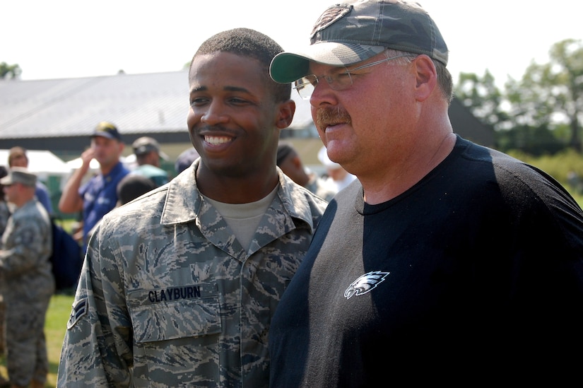Philadelphia Eagles head coach Andy Reid stops for a photo with an Airman from McGuire Air Force Base, N.J., during Military Day at the Eagles training camp Aug. 5, 2008, at Lehigh University in Lehigh, Penn.  More than 200 military members from all the services, including more than 50 Airmen from McGuire Air Force Base and Fort Dix, N.J., attended the event where they were served breakfast and held a meet and greet with Eagles staff and players.  (U.S. Air Force Photo/Tech. Sgt. Scott T. Sturkol)