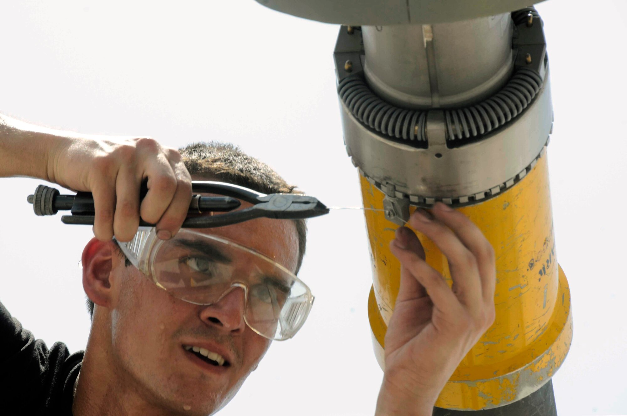 Airman 1st Class Jason Linehart applies safety wiring to a drogue adapter of a KC-135 Stratotanker boom July 24 at a Southwest Asian air base. The drogue adapter enables the KC-135 to refuel aircraft with different receiver systems. Airman Linehart is a 379th Expeditionary Aircraft Maintenance Squadron crew chief deployed from McConnell Air Force Base, Kan. (U.S. Air Force photo/Staff Sgt. Darnell T. Cannady) 
