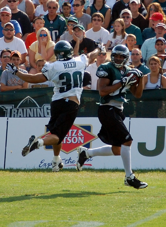Philadelphia Eagles wide receiver Hank Baskett (84) hauls in a pass past Eagles safety J.R. Reed (30) during practice at the Eagles training camp at Lehigh University in Lehigh, Penn., Aug. 5, 2008.  Mr. Baskett is the son of a 30-year Air Force veteran and participated in signing autographs and meeting more than 200 military members attending the training camp for the Eagles' Military Day Aug. 5.  (U.S. Air Force Photo/Tech. Sgt. Scott T. Sturkol)