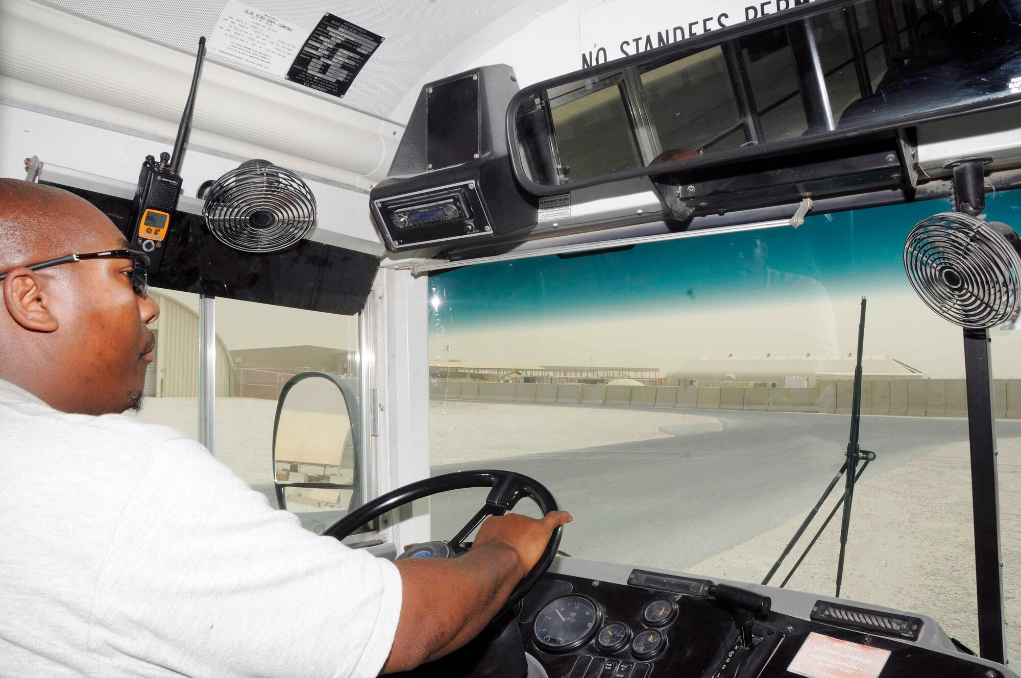 Terence Purifoye picks up and drops off passengers at a bus stop July 22 at a Southwest Asian air base. Mr. Terence is a 379th Expeditionary Logistics Readiness Squadron vehicle operator from Miami. (U.S. Air Force photo/Staff Sgt. Darnell T. Cannady) 
