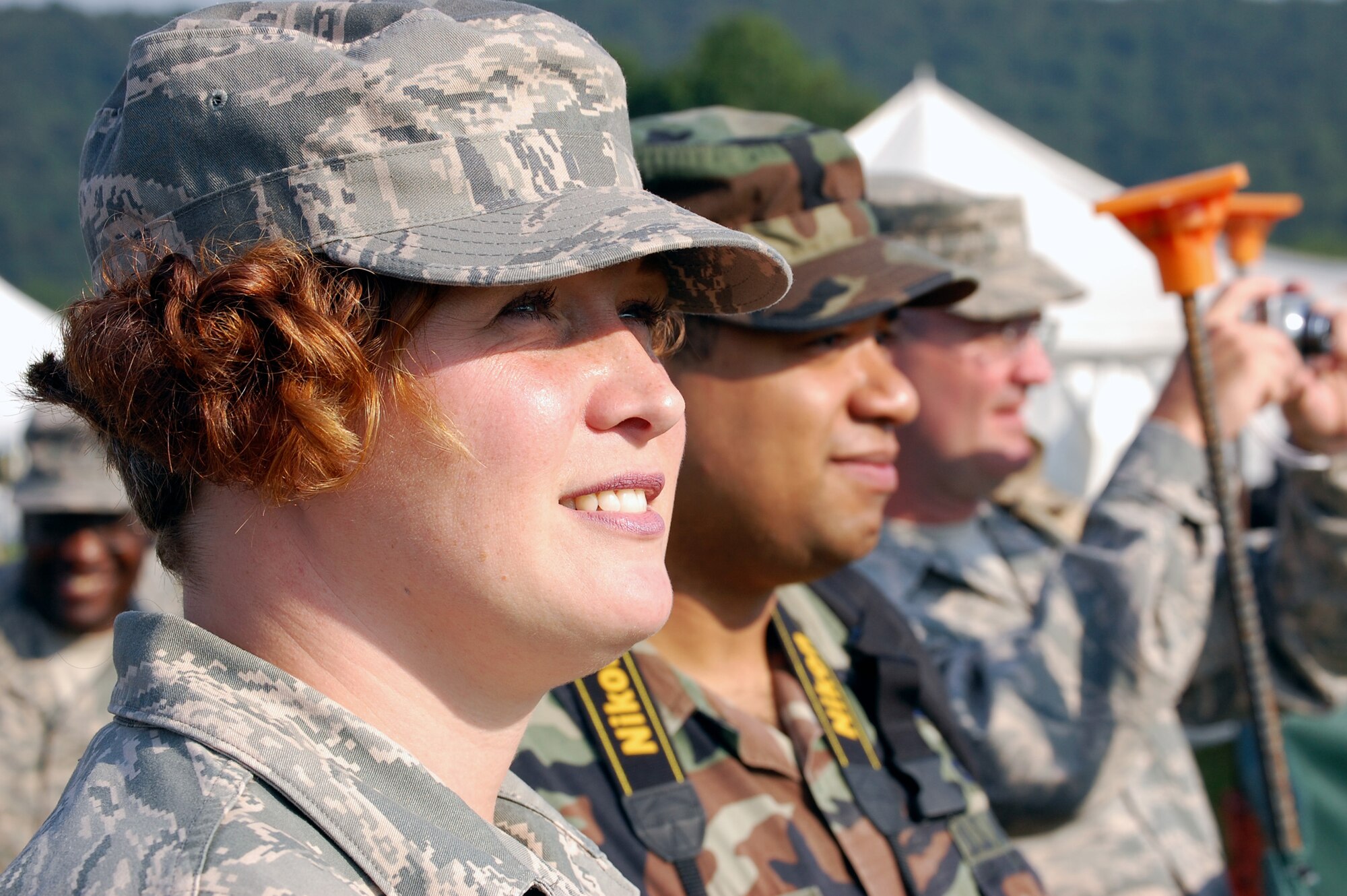 Tech. Sgt. Christine Sanders, Staff Sgt. Veuril McDavid and Tech. Sgt. William Lipsett, all from the U.S. Air Force Expeditionary Center at Fort Dix, N.J.,  watch with other military members the National Football League's Philadelphia Eagles practice on a field at Lehigh University in Lehigh, Penn., Aug. 5, 2008.  The presence of military members In Lehigh was part of the Philadelphia Eagles' Military Day at their training where more than 200 service members took part from all branches of service.  (U.S. Air Force Photo/Tech. Sgt. Scott T. Sturkol)
