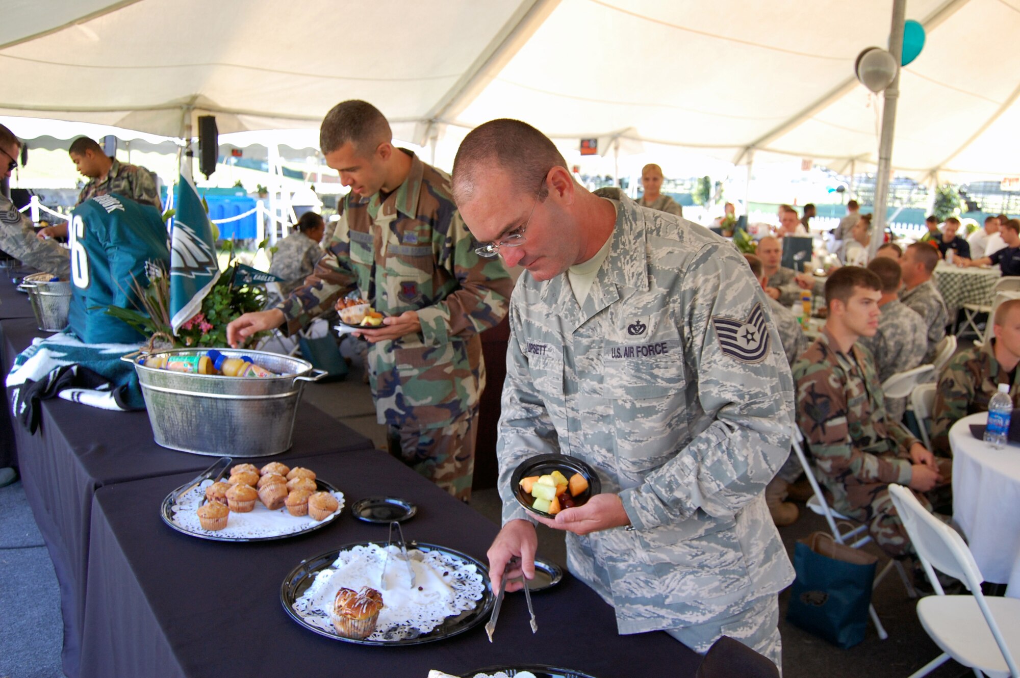 Tech. Sgts. Zachary Christman and William Lipsett, both from the U.S. Air Force Expeditionary Center on Fort Dix, N.J., pick out some breakfast items provided by the Philadelphia Eagles and the USO during a military appreciation event at the Eagles training camp at Lehigh, Penn., Aug. 5, 2008.  Both Airmen were part of a group of more than 200 servicemembers who attended the event that included breakfast and a meet and greet with Eagles staff and players.  (U.S. Air Force Photo/Tech. Sgt. Scott T. Sturkol)