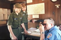 Tom Perkins, a senior engineer with Calspan, support contractor at Arnold (1986) and a former Tullahoma Civil Air Patrol Cadet Squadron commander, shows two cadets, Aaron Oaks and Tom Lirnbaugh, how to operate a signal mirror. Perkins' career spanned more than 30 years . AEDC Fellow Dr. Bill Baker said Perkins was an expert in flutter work and store separation testing and analysis. (AEDC file photo)  