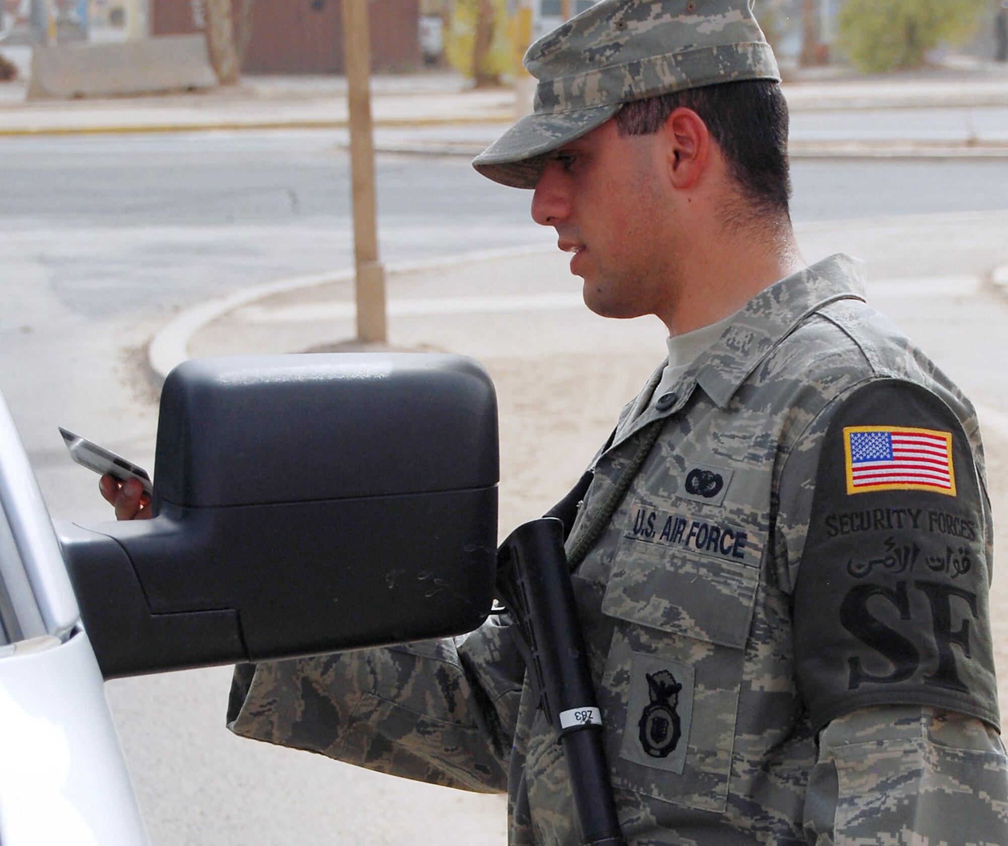 Airman 1st Class Murad Mohiadeen checks the identification of a vehicle operator at an entry control point to the Air Force Theater Hospital Aug. 2 at Joint Base Balad, Iraq. Airman Mohiadeen, a native of Baghdad, was raised in the United States after his family emigrated from Iraq in 1990. Airman Mohiadeen is a security forces apprentice with the 332nd Expeditionary Security Forces Squadron and is deployed from Royal Air Force Lakenheath, England. (U.S. Air Force photo/Staff Sgt. Don Branum) 
