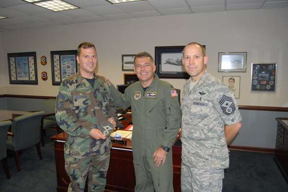Chief Master Sgt. Douglas Ackerman, 3rd Aerial Port Squadron, poses with 43rd Airlift Wing Commander Col. John McDonald and 43rd AW Command Chief Michael Grimm after being announced as the new 43rd AW Command Chief August 6. Chief Ackerman will take over for Chief Grimm on August 28, when Chief Grimm leaves to become the command chief for the 21st Expeditionary Mobility Task Force at McGuire Air Force Base, N.J.