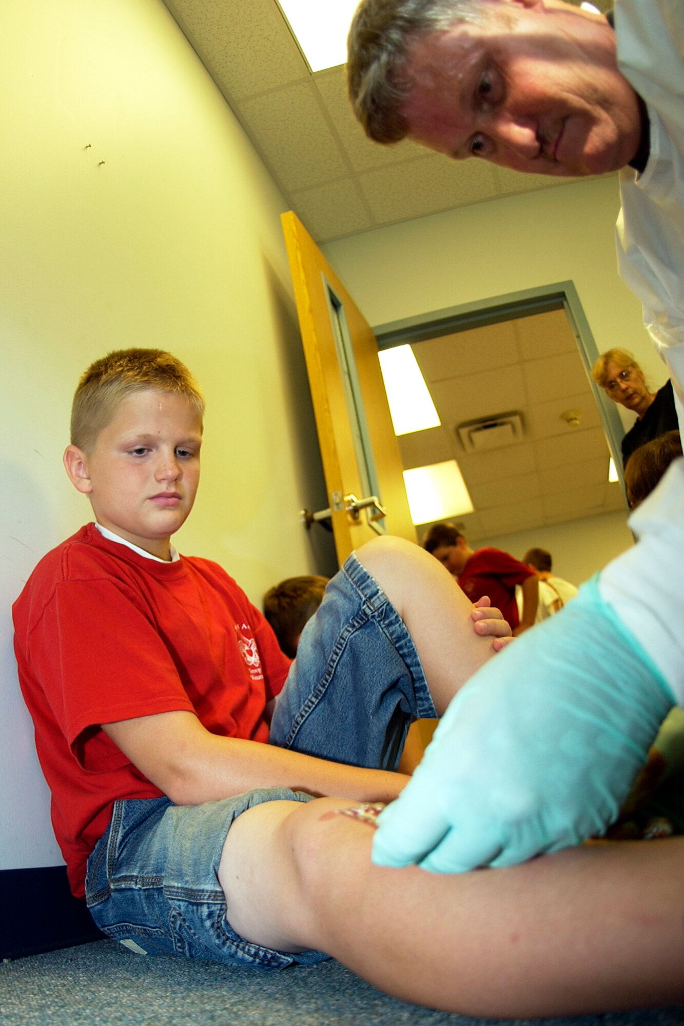 GRISSOM AIR RESERVE BASE, Ind., -- Master Sgt. Robert Summers, 434th Aerospace Medicine Squadron, applies moulage to the leg of a Boy Scout who will play the role of an 'accident victim' during a self aid/buddy care exercise. The Boy Scouts helped the clinic test Grissom members on SABC skills during the August unit training assembly. (U.S. Air Force photo/Tech. Sgt. Doug Hays)