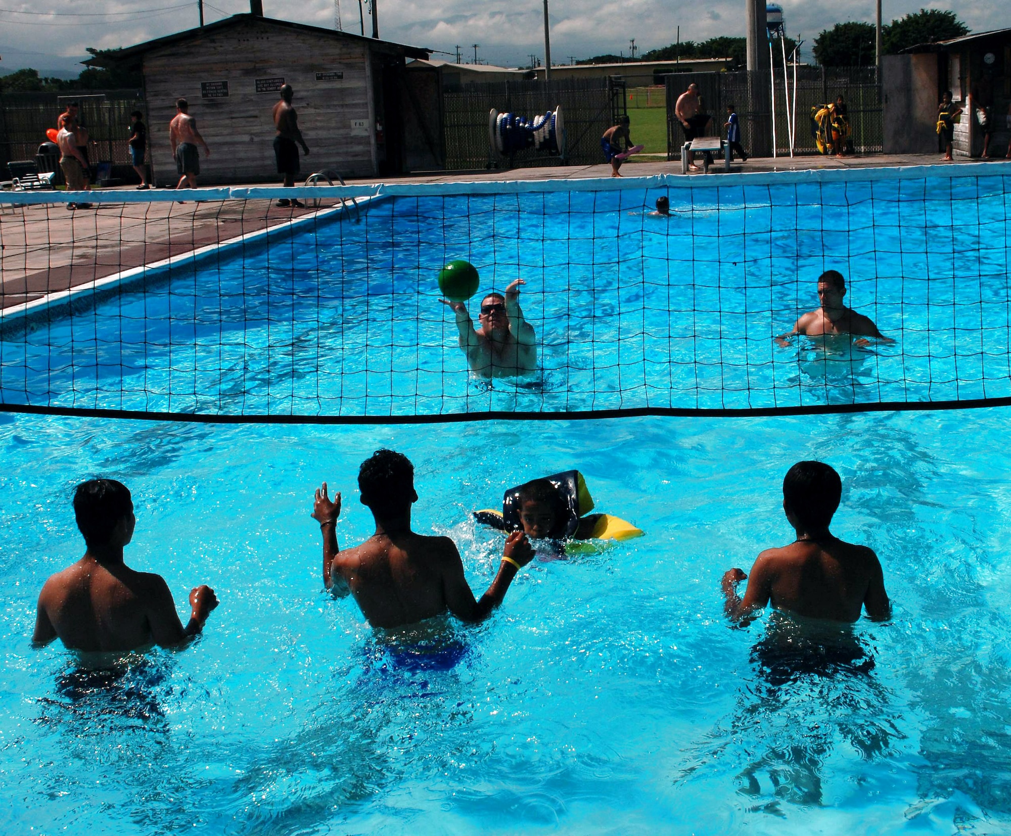 Servicemembers from Soto Cano Air Base, Honduras, play volleyball in the base pool with boys from the Hogar de Ninos Nazareth Orphanage in Comayagua, Honduras. Nearly 60 Soldiers, Sailors and Airmen volunteered for the orphanage kids' day Aug. 2 on base.   (U.S. Air Force photo)
