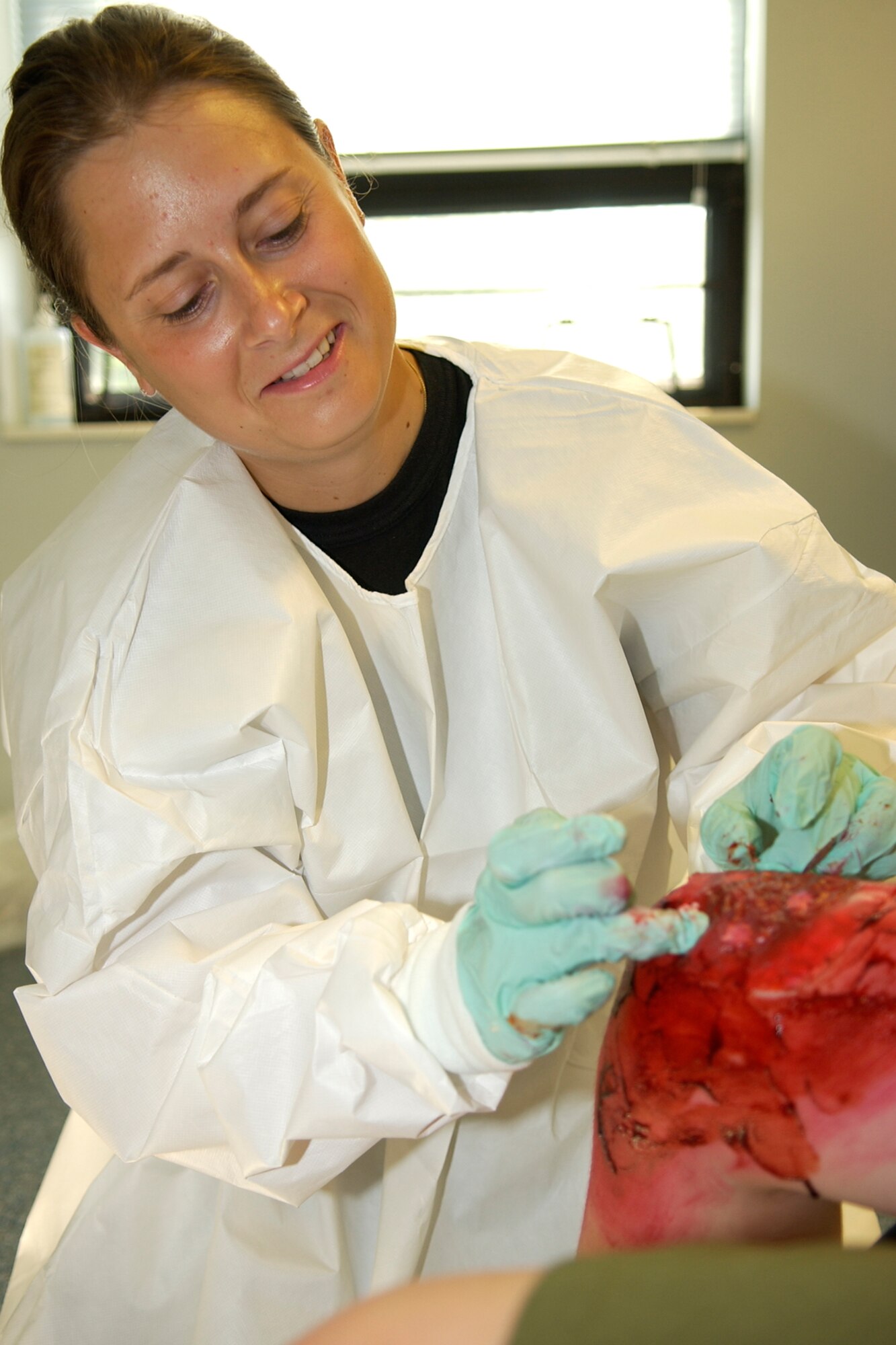 GRISSOM AIR RESERVE BASE, Ind., -- Senior Airman Anna MacLeod, 434th Aerospace Medicine Squadron, applies moulage to the knee of a boy scout in preparation for a self aid/buddy care exercise held during the August unit training assembly. (U.S. Air Force photo/Tech. Sgt. Doug Hays)