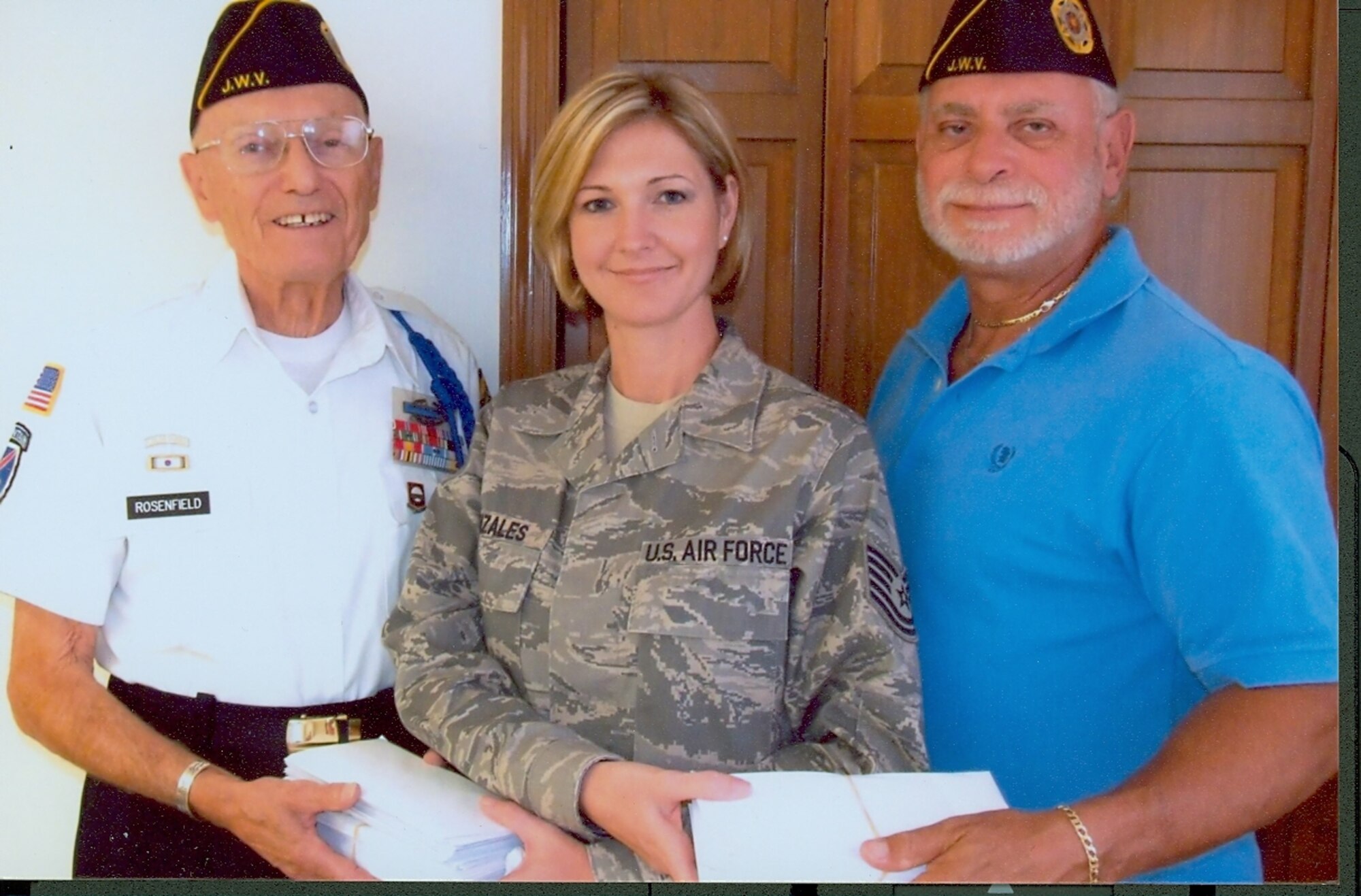 Tech. Sgt. Monica Gonzales from the Airman and Family Readiness Center accepts 100 phone cards from George Rosenfield (left) and Gary Stern, representatives of the Jewish War Veterans Brevard Post 639, for Patrick Air Force Base military personnel being deployed to the Middle East. (Photo by Paul Licker)