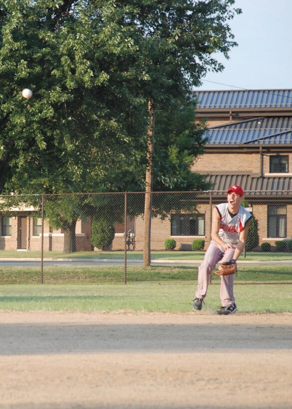 Staff Sgt. David A. Hagan II, 89th Aerial Port Squadron passenger service agent, throws a ball to home plate from left-center field for the out to end the inning Aug. 4. (U.S. Air Force photo by Airman Katie L. Justen)