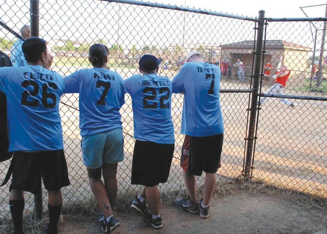 Members of the 79th Medical Group softball team watch from their dugout while members of the 89th Aerial Port Squadron team are at bat.  The 89 APS won the first game 13-12, and the 79 MDG won the second game 9-7, Aug. 4. (U.S. Air Force photo by Airman Katie L. Justen)