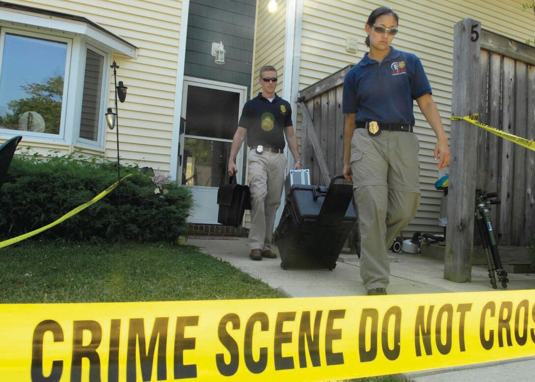 Special Agents Martha Ward and Bryan Schmelzer, Forensic Science Consultants, 2nd Field Investigations Squadron, AFOSI Region 7, depart from a house they used for training July 17. (U.S. Air Force photo by Senior Airman Renae Kleckner)