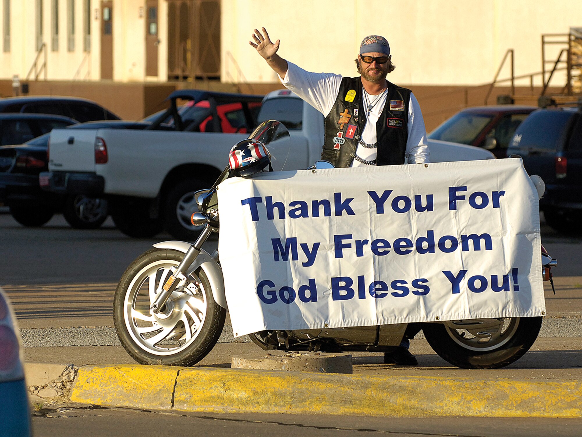 Elton Nimmo greets Tinker workers inside the Eaker Gate Wednesday and will smile and wave them home in the evening from inside the Vance Gate, The disabled veteran Army radio operator began waving, and often saluting, to those in uniform Aug. 1 with the passion to let the military know they are appreciated.  “Troops don’t get enough recognition,” the retired private first class said.  “I’d like to line up each troop and shake each hand.  If I can make their day a little brighter, let them know what they’re doing makes a difference, than I go home feeling good.”  Mr. Nimmo’s stepson is a Tinker security forces airman currently deployed and his son is with the Army, stationed at Peterson, AFB., Colo.   Asked if the recent 106-degree days were an issue,  he shrugs it off and waves at the next driver.  “It’s a lot hotter in Iraq”, he said.  (Air Force photo/Margo Wright)

