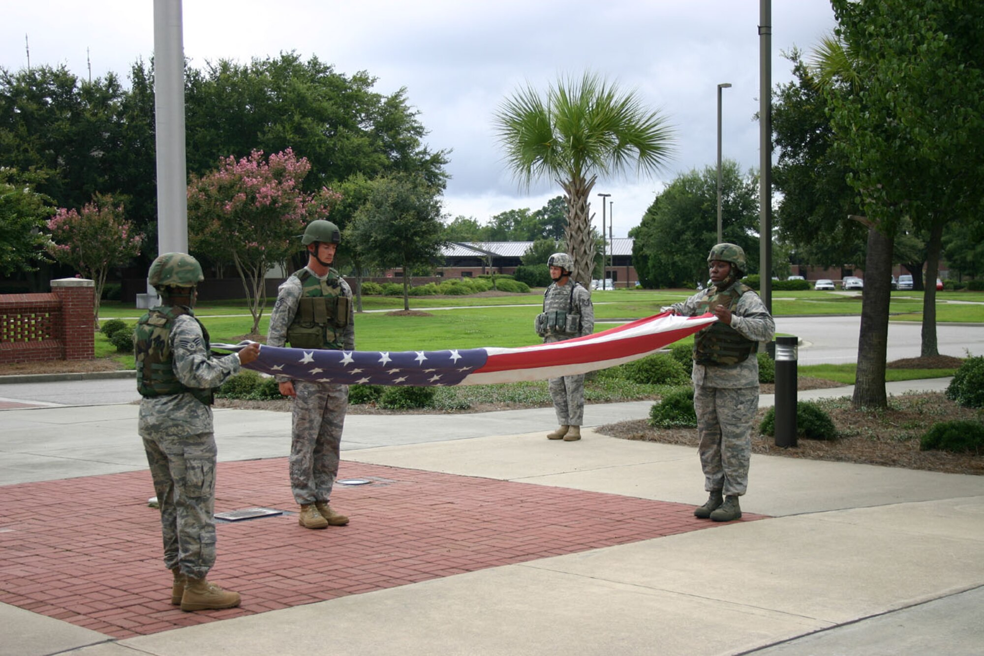 SEYMOUR JOHNSON AIR FORCE BASE, N.C. -- Senior Airman Veronica Odom (left) supports the time-honored tradition of retreat at Charleston Air Force Base, S.C.  Airman Odom, a Reservist with the 916th Security Forces Squadron, is currently working on active duty with the 437th Security Forces Squadron. More than 40 members of the 916th Security Forces are currently deployed overseas or working stateside augmenting active duty forces.