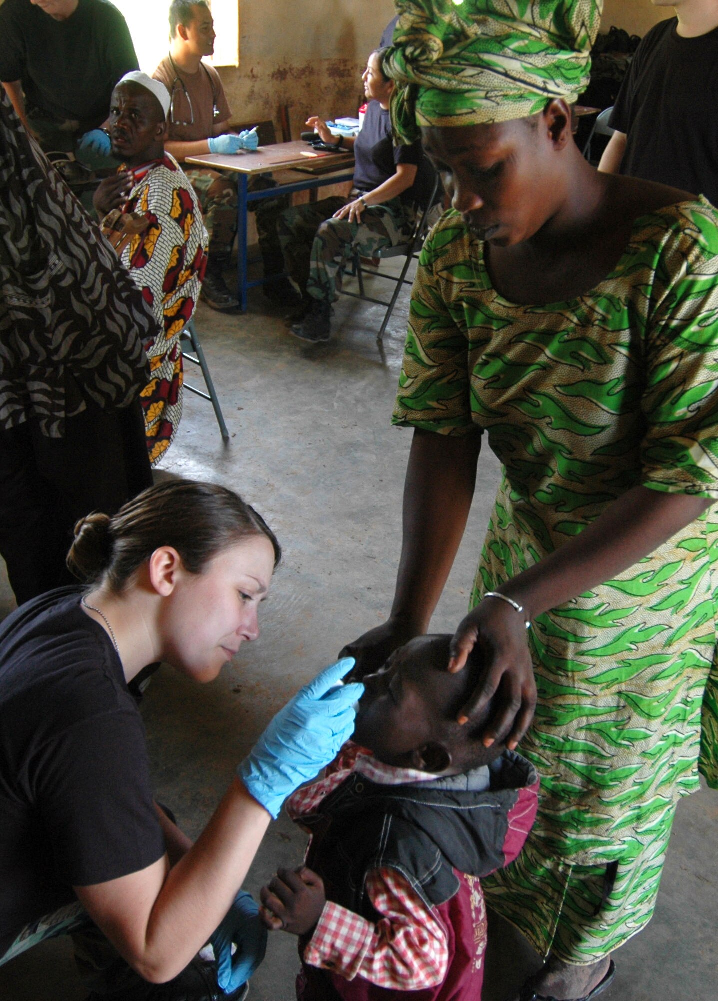 Senior Airman Alicia Mangan takes the temperature of a little boy July 24 in a village outside of Bamako, Mali. American servicemembers traveled to four villages during a series of humanitarian outreach visits. Airman Mangan is deployed from Royal Air Force Lakenheath, England. (U.S. Air Force photo/Senior Airman Justin Weaver)